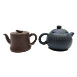 Two Chinese Yixing teapots, the first with a blue ground and rows of calligraphy and seal mark,