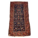 A Hamadan rug, North West Persia, the indigo field with an all over design of serrated leaves,