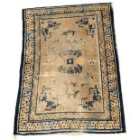 An early Chinese rug, the muted gold field with a circular floral medallion, leafy vines and moths,