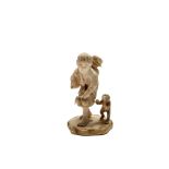A Japanese ivory okimono of a flower picker and a monkey, Meiji Period, signed, height 8cm.
