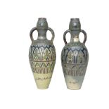 A large pair of Moroccan pottery twin handled vases, each with Islamic script,