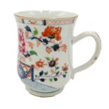 A Chinese Imari porcelain tankard, 18th century, with bamboo and flowering trees before a fence,