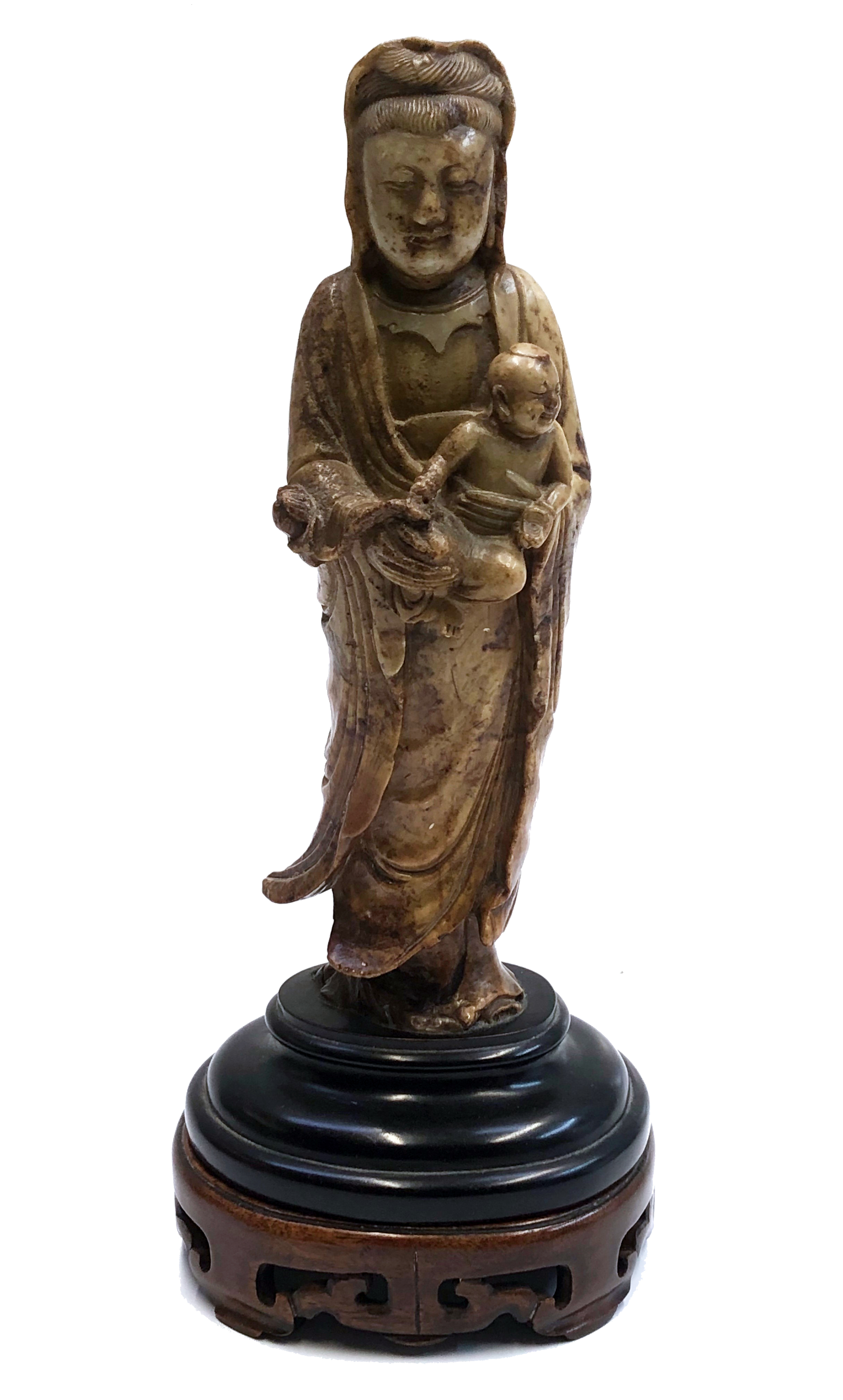 A Chinese soapstone figure of Guanyin holding a child, late 18th/early 19th century,