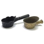 A Chinese bronze pan iron, 19th century, with a wooden handle, length 28cm and a brass pan iron,