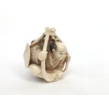 A Japanese ivory netsuke of a seated man, circa 1900, signed, height 4.5cm, width 4cm.