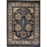 A Chinese rug, the indigo field with seven stepped polychrome medallions,