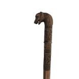 An Anglo-Indian carved sandalwood walking cane, late 19th century, with a mythical beast handle,