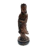 A Chinese carved wood figure of the Goddess Guanyin, holding a set of prayer beads in her left hand,