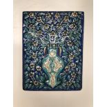 A Persian pottery tile, Qajar period, depicting a vase of flowers on a blue ground, 29 x 22cm.