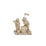 A Japanese carved ivory okimono group of a couple pounding dough, Meiji period, signed, height 12cm,