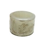 Chinese jade nephrite archers ring, carved with may blossom and bamboo, gold coloured decoration,