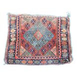 A Jaff bag pillow, with rows of polychrome lozenge hooked guls,
