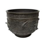 A Japanese bronze large jardiniere, circa 1900, cast in relief with birds of prey amidst branches,