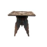 An Indian carved hardwood occasional table, the square top carved with flowers and fruit,