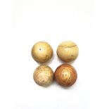 Four ivory billiard balls, circa 1900, three measuring 5cm and one at 4.5cm diameter.