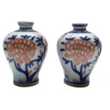 A pair of Chinese porcelain baluster vases, 20th century, decorated with trees and foliage,