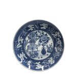 A Chinese blue and white porcelain charger, decorated with vases of flowers,