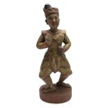 A Chinese carved wood figure of a man, circa 1900, in traditional dress,