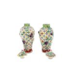 A near pair of Chinese famille rose vases and covers, circa 1900,