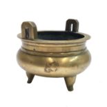 A Chinese polished bronze censer, 19th century, the pair of handles flanking a bulbous body, Xuande,