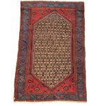 A Hamadan rug, North West Persia, with a large camel trellis medallion, madder gul spandrels,