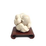 A Japanese ivory figure of a seated man with head in hands, circa 1900-1920, signed, height 7cm,