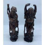 A pair of Chinese hardwood figures, late 19th century, height 32cm.