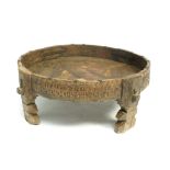 An Indian wooden circular table, with a carved solid gallery on four shaped legs, height 30cm,