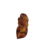 A Chinese carved amber model of a monkey, length 5cm.