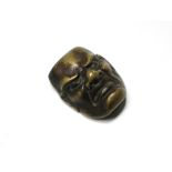 A Japanese miniature bronze mask, 4 x 3cm.