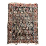 An Afshar rug, South West Persia, the indigo field with rows of polychrome boteh, animals and guls,