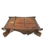 An Indian carved hardwood low table, with iron mounts, height 38cm, width 136cm, depth 134cm.