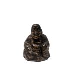 A Chinese gilt bronze scroll weight, Qing period, in the form of a seated buddha, height 4.