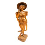 A large Burmese carved wood statue of a semi naked lady,