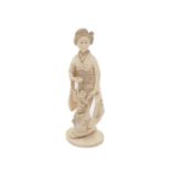 A Japanese carved ivory okimono of a standing geisha, 19th century, holding a basket of flowers,