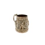 An Indian silver mug, circa 1900, the body repousse decorated with deities,