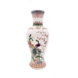 A Chinese famille verte baluster vase, late 19th century, with peacock and hen in a rocky garden,
