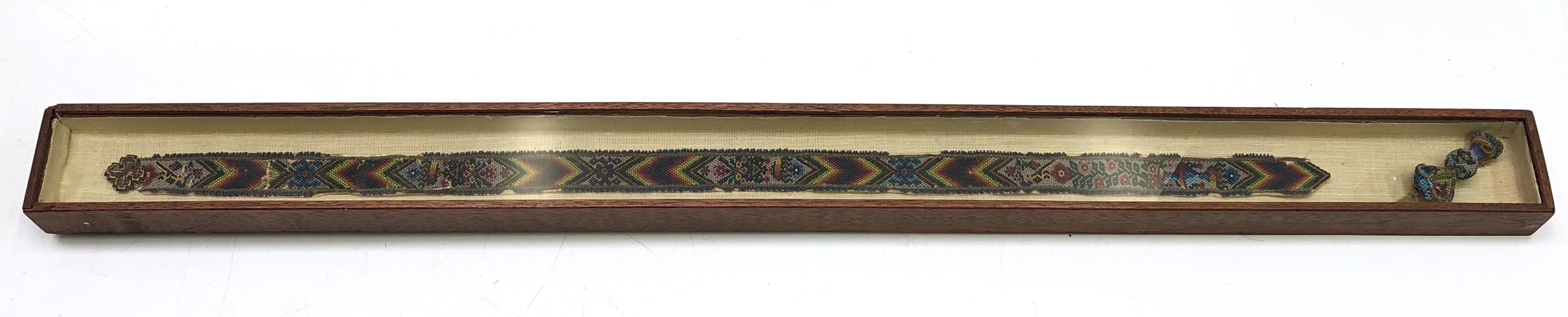 A Chinese beadwork belt, 19th century, framed and glazed, length 63cm.