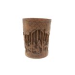 A Chinese bamboo brush pot, 19th century, carved with numerous figures, signed to the base,