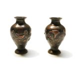 A pair of Japanese bronze baluster vases, Meiji, decorated with birds and flowering branches,