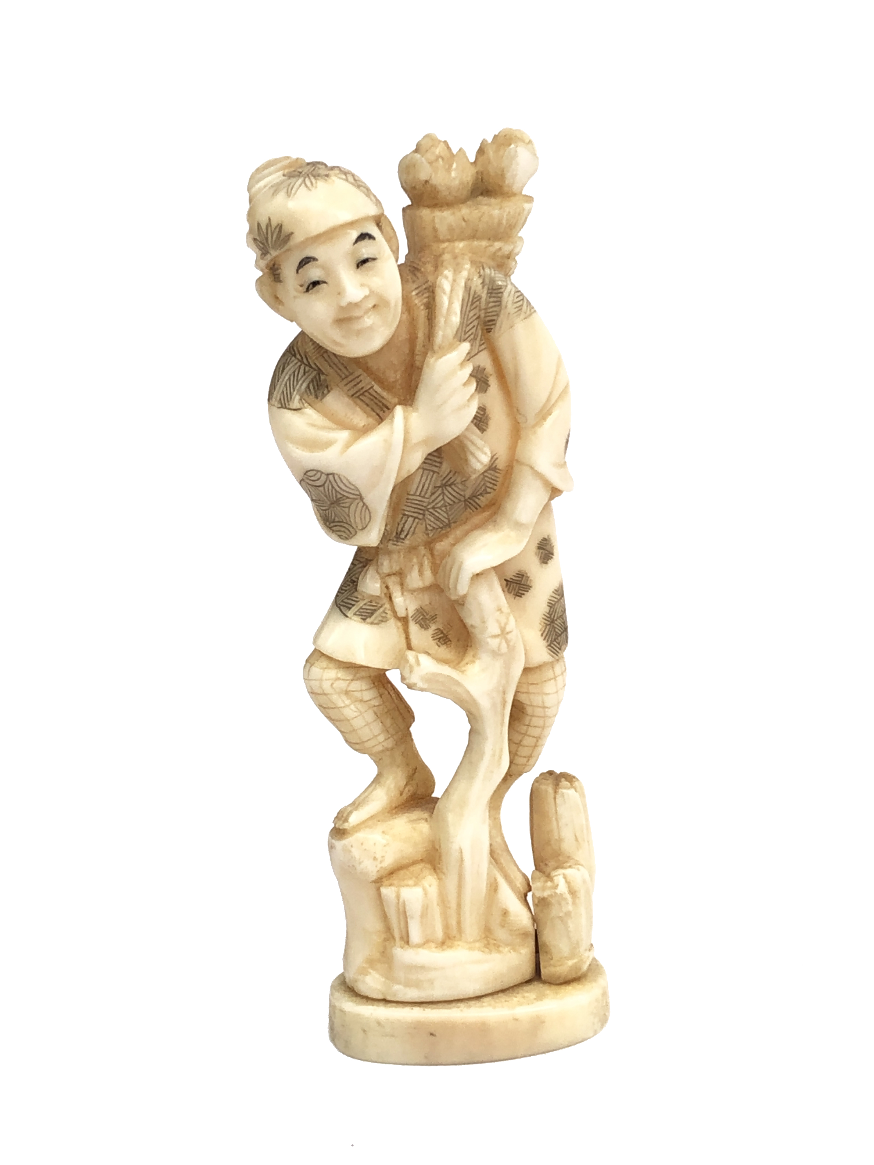 A Japanese ivory okimono of a farmer, circa 1900, with a bundle of flowers over his shoulder,