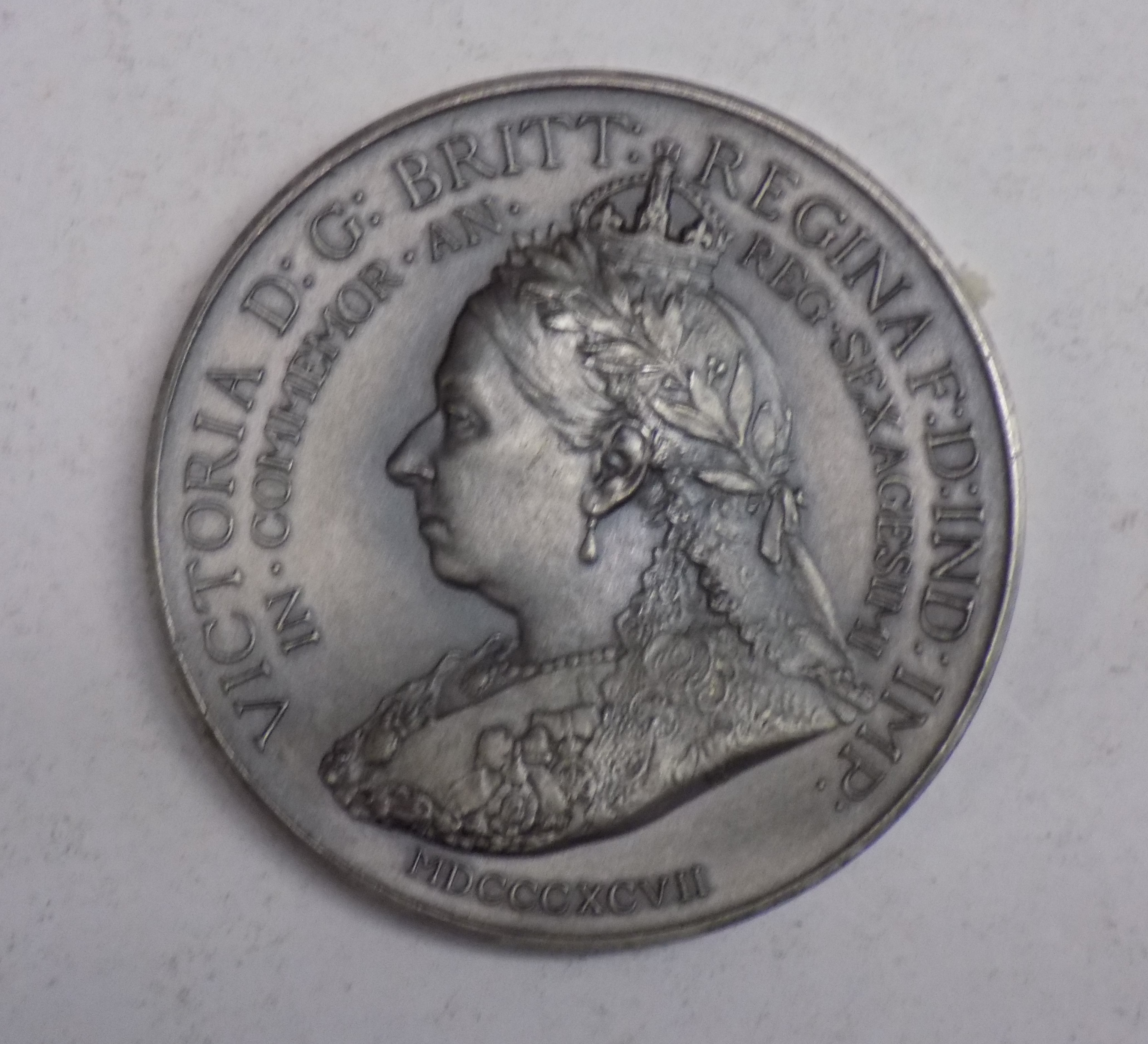 An 1897 Queen Victoria Jubilee Army and Navy token.