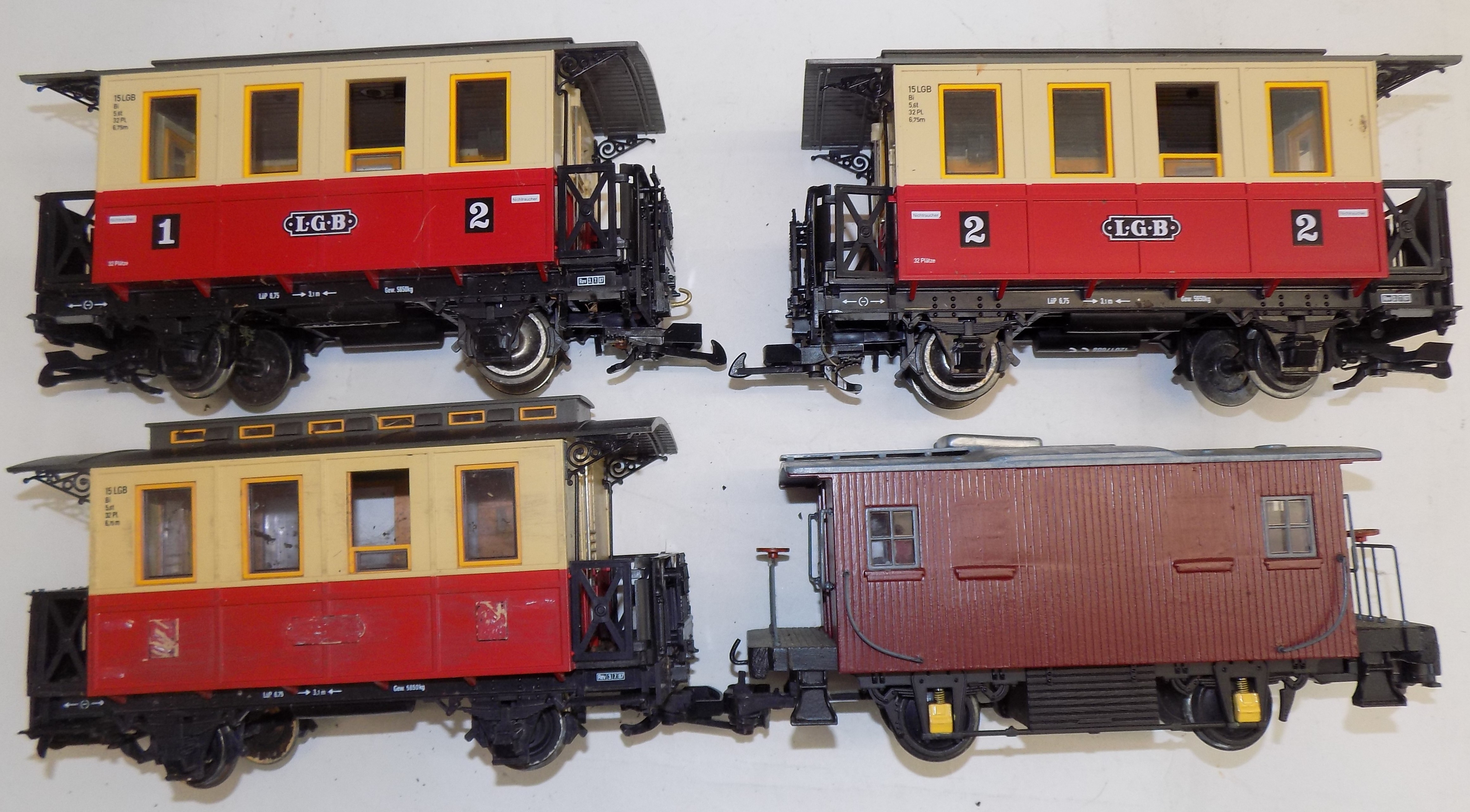 Three Marklit 2" gauge carriages and one other carriage.