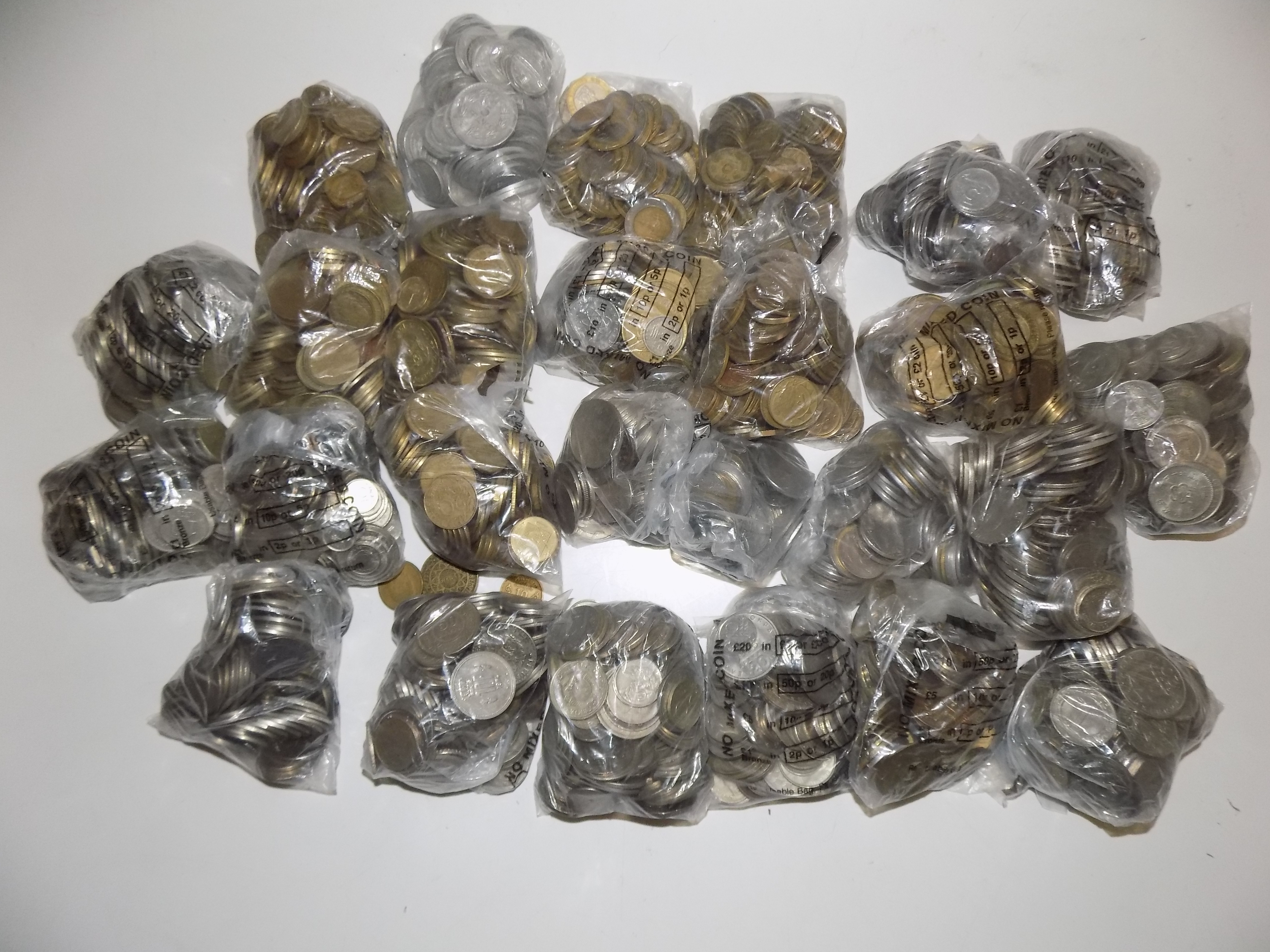 A very heavy accumulation of World coins in plastic bank bags.