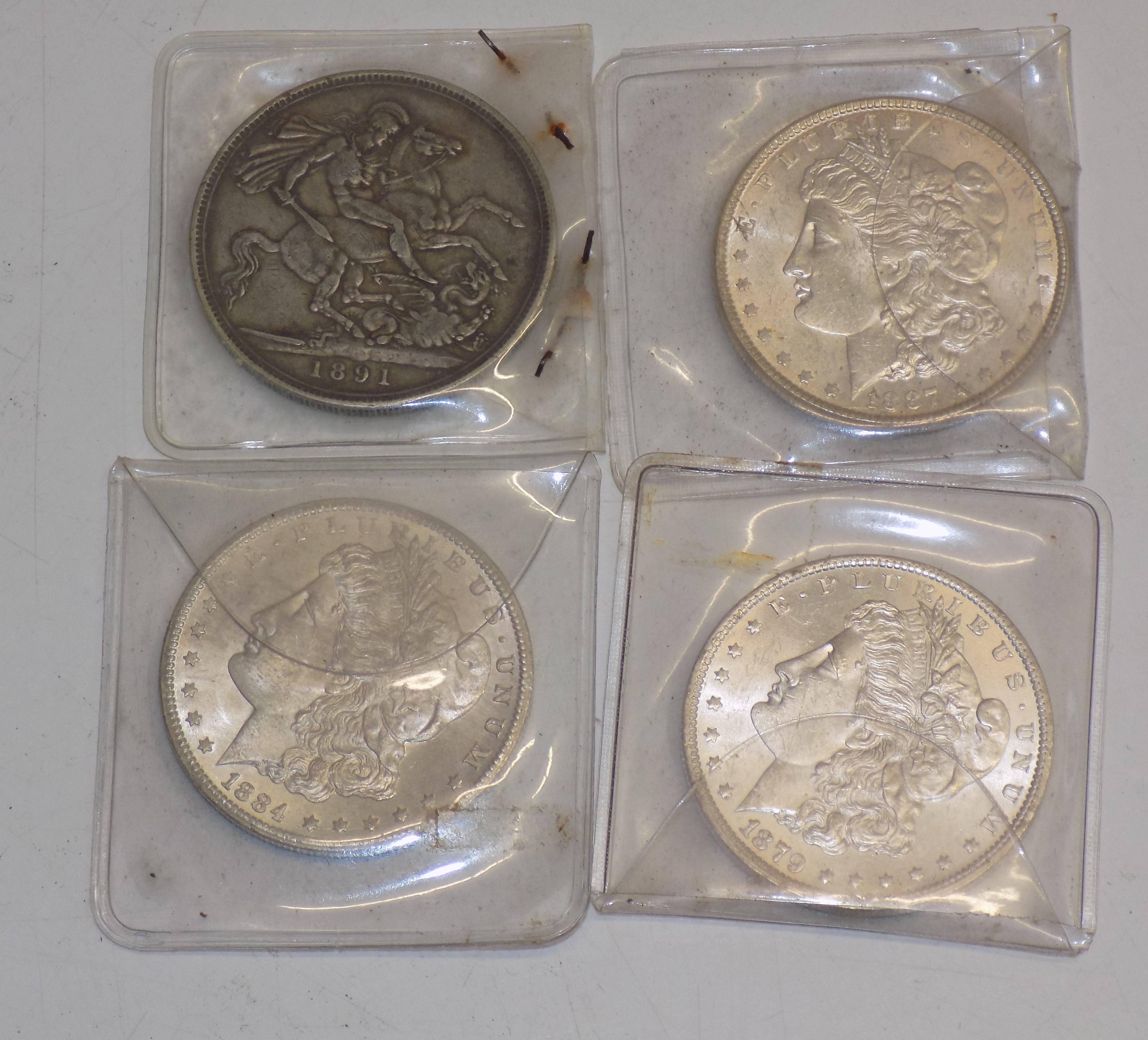 Crown :- 1891 together with three U.S.A. silver dollars, 1879, 1884 and 1887.