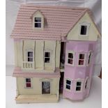 A modern wood dolls house, the two doors open to reveal rooms,