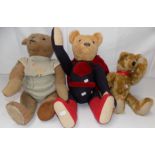 Three plush covered teddy bears,