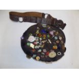 A cap with many enamel and other badges, together with a scout belt.
