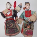 Two composition oriental dolls and a miniature porcelain fully articulated doll.