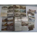 A quantity of Cornish postcards contained in two albums and loose.